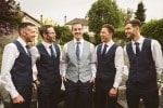 groom-groomsmen-laughing-garden