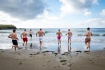 the groomsmen run towards the sea for a morning swim before the wedding ceremony at  Inchydoney Lodge and Spa
