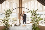 A bride and groom cut their wedding cake at Inchydoney Lodge and Spa