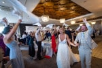 A bride and groom are welcomed by their cheering guests at Inchydoney Island Lodge and Spa