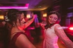 A bride and her bridesmaid dance together at Inchydoney Island Lodge and Spa