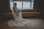 A bride sits alone, looking at the sea from the bridal suite at Inchydoney Island Lodge and Spa