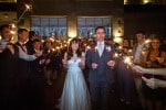A bride and groom carry sparklers through a line of their guests at Inchydoney Island Lodge and Spa