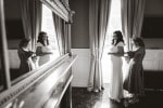 A bride and her mother reflected in a mirror