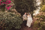 A bride and groom walk through the gardens at the Maryborough hotel