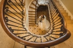 A bride and groom dance at the bottom of an ornate staircase after their wedding in the Maryborough Hotel in Cork