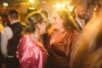 Wedding guests talking and dancing
