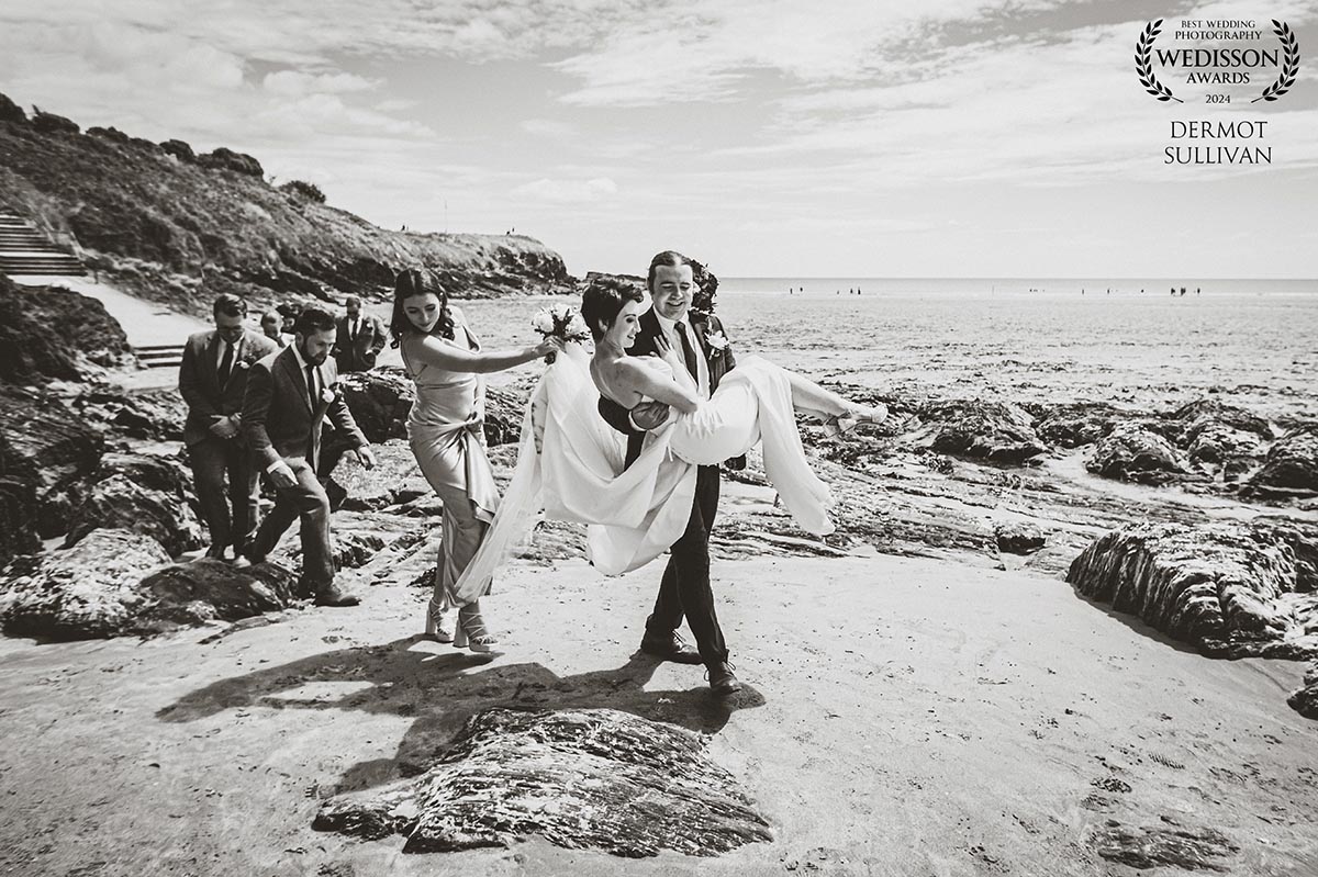 groom-carries-bride-across-inchydoney-beach A groom carries his bride across Inchydoney Beach - Irish wedding on a beach